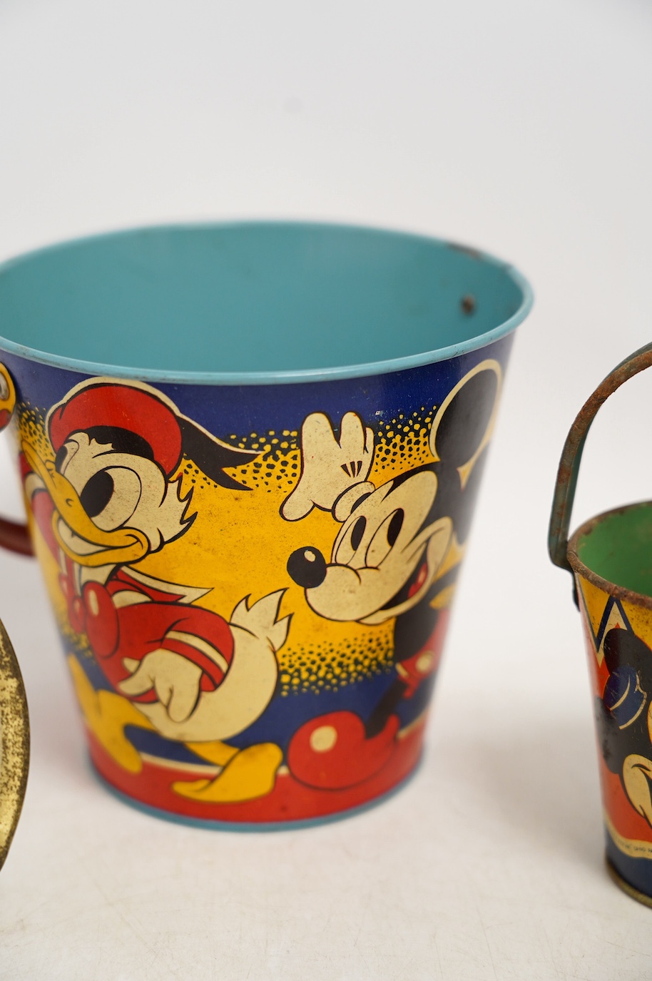 A vintage Bull Dog Bass and Guinness tinplate advertising ashtray, two Happynak Mickey Mouse toy buckets, a bakelite dog collar, etc. (5). Condition - fair